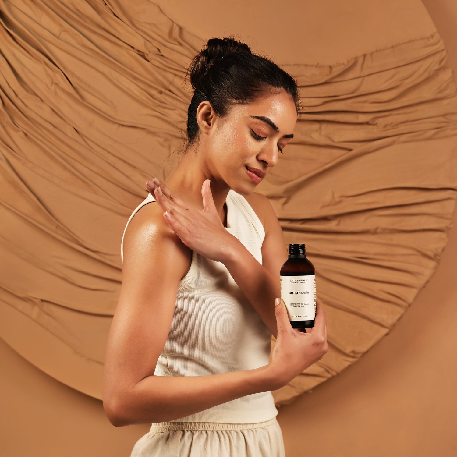 Art of Vedas Ayurveda Thailams Guide - Woman Applying Ayurvedic Herbal Oil for Authentic Abhyanga Massage Therapy